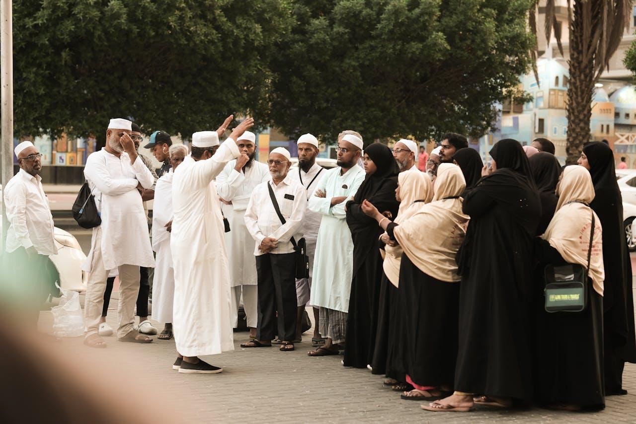 Umrah guides explaining rituals and instructions to pilgrims in Makkah and Medina
